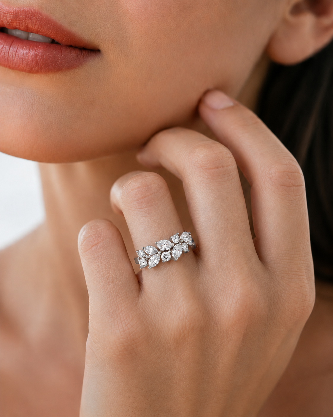 color_925_SIL,color_935_ARG,color_10K_WG, color_14K_WG &&	
A close-up lifestyle shot of a woman wearing a silver band ring set with multiple round-cut diamonds on her finger.