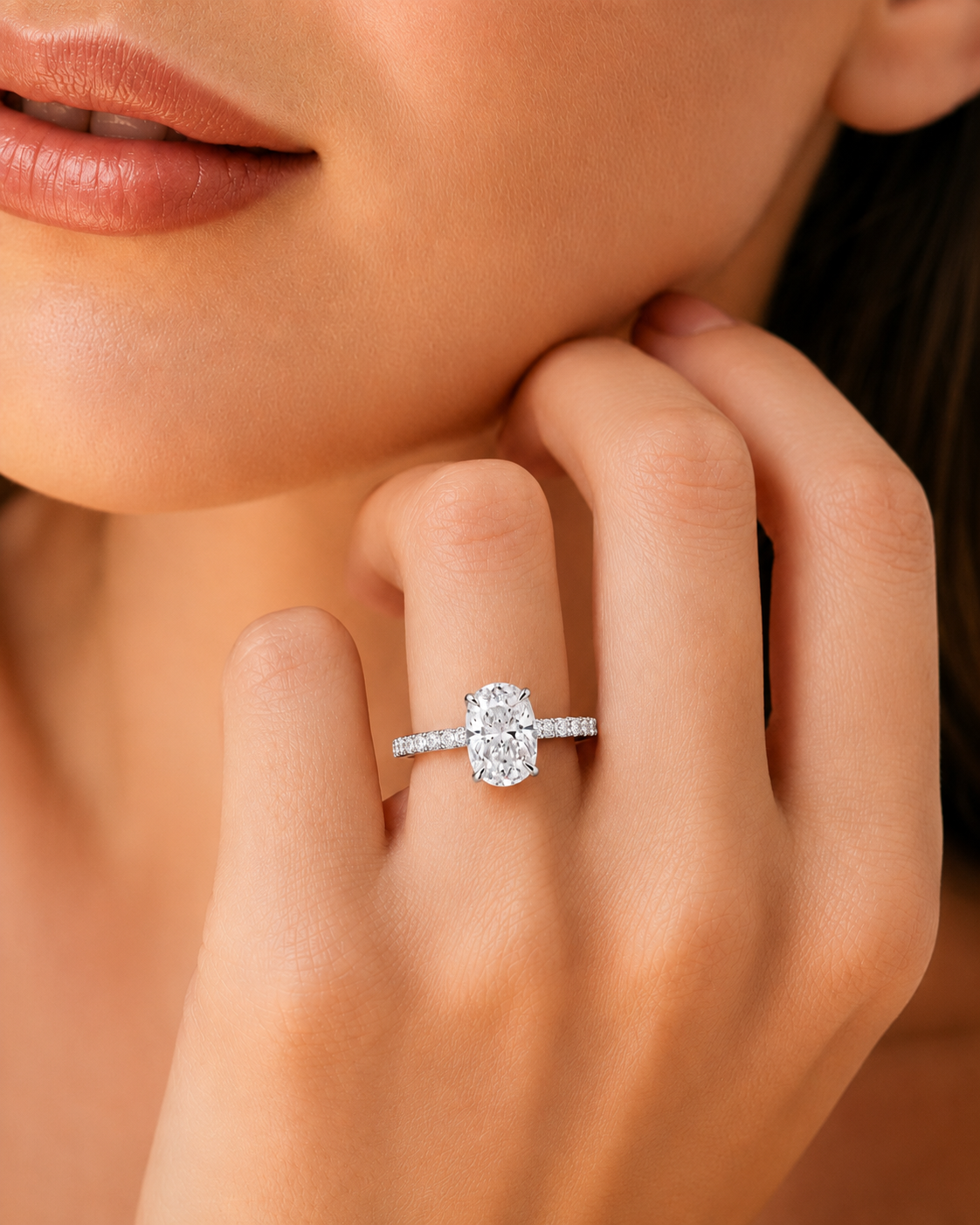 color_925_SIL,color_935_ARG,color_10K_WG, color_14K_WG &&A close-up lifestyle shot of a woman wearing a silver-toned diamond ring with a marquise-cut center stone on her finger.