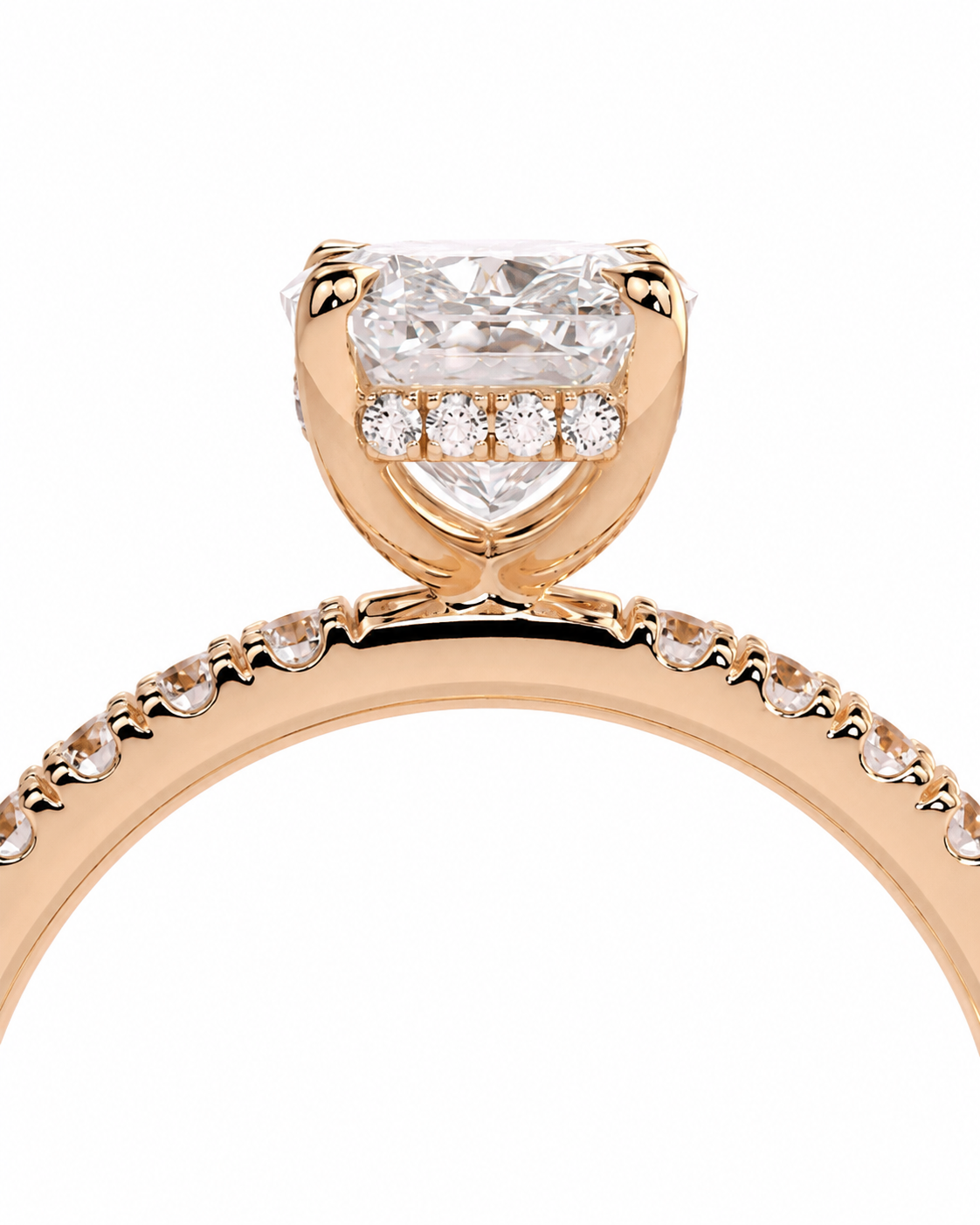 color_10K_RG, color_14K_RG &&A close-up of a rose gold engagement ring featuring a large cushion-cut diamond center stone and a halo of smaller round diamonds, with a pave band on a white background.