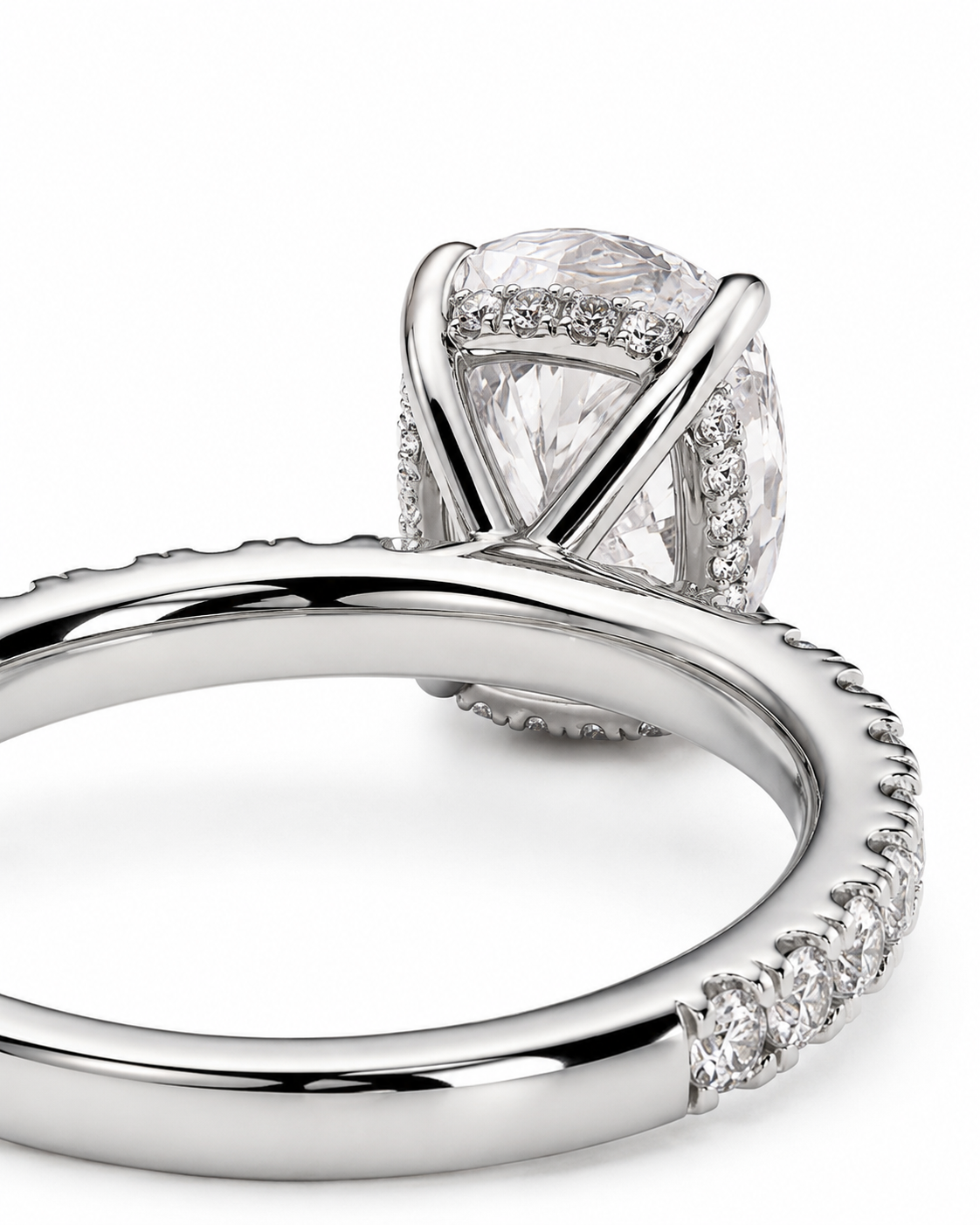 color_925_SIL,color_935_ARG,color_10K_WG, color_14K_WG &&A close-up studio shot of a silver-toned engagement ring featuring a large cushion-cut diamond center stone in a four-prong setting, with pave diamonds along the shoulders and band.