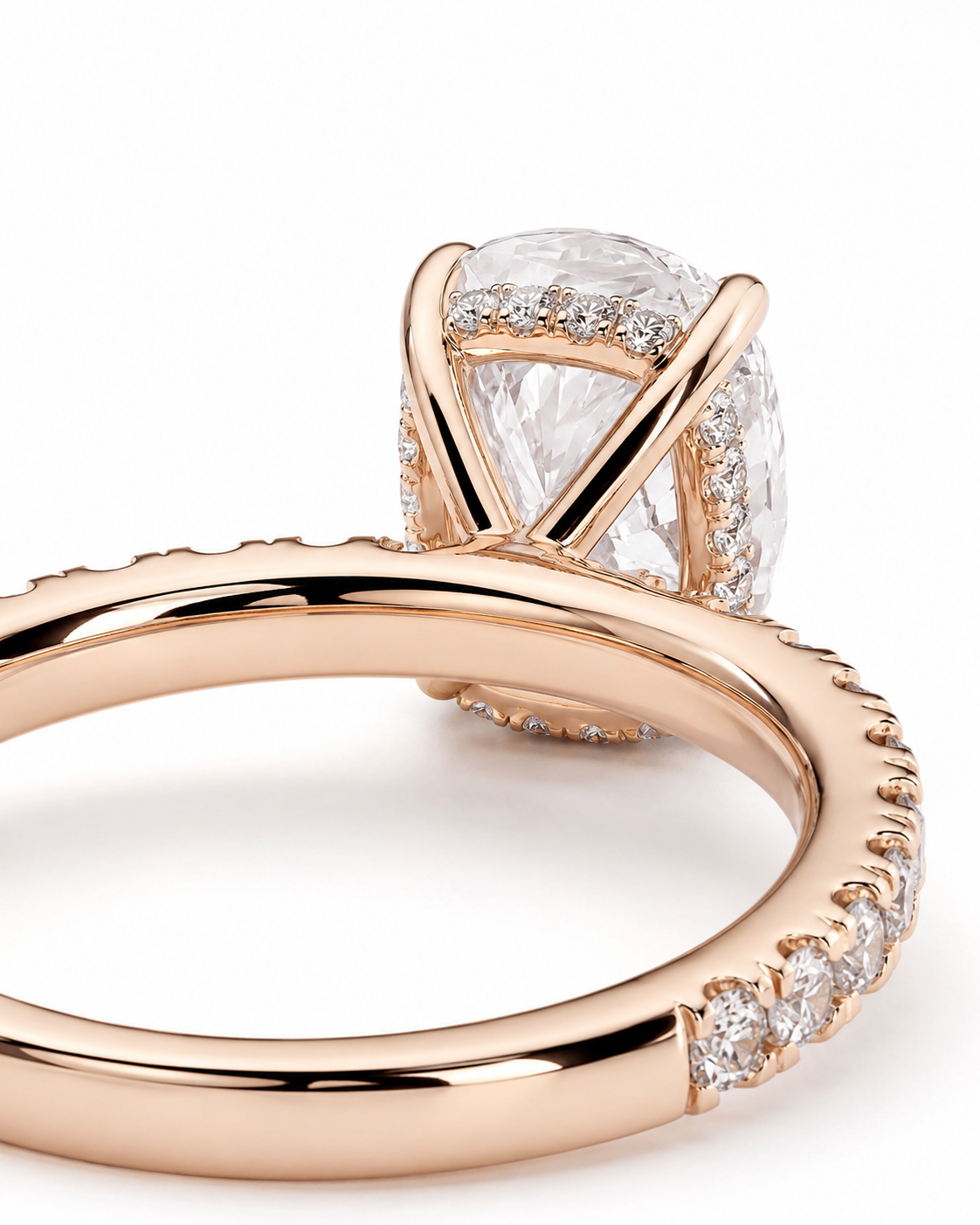 color_10K_RG, color_14K_RG &&Rose gold engagement ring with a large oval-cut clear center stone and pave-set accent stones along the band, shown on a clean white background.