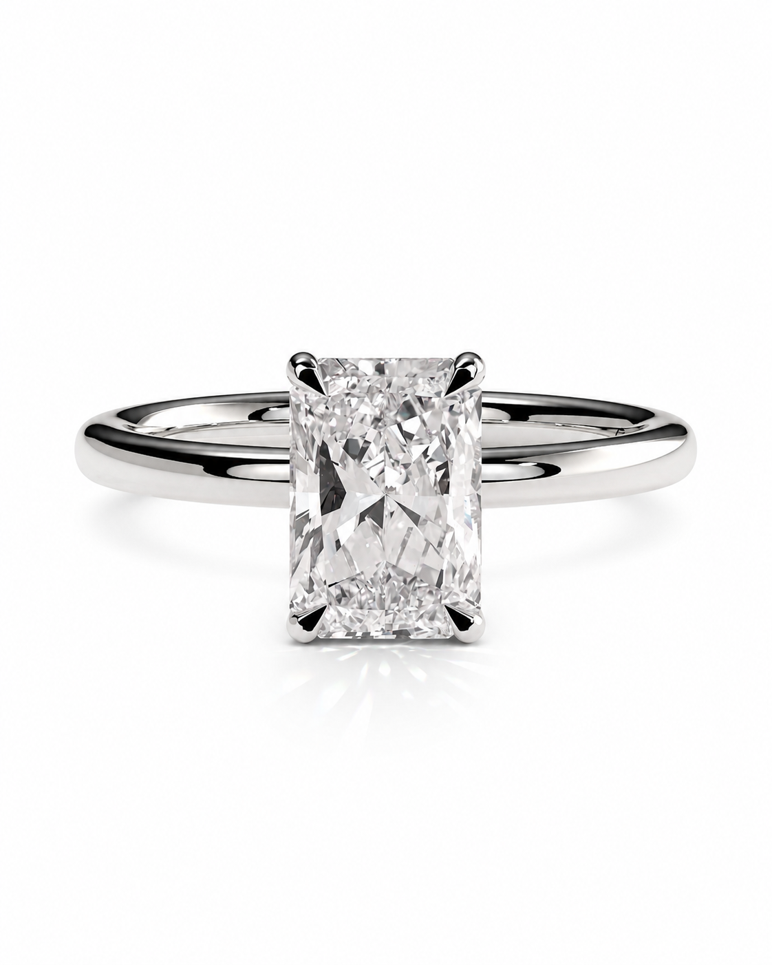 color_925_SIL,color_935_ARG,color_10K_WG, color_14K_WG &&An radiant cut diamond engagement ring in a polished silver-colored metal band, centered on a clean white background with a soft reflection below.