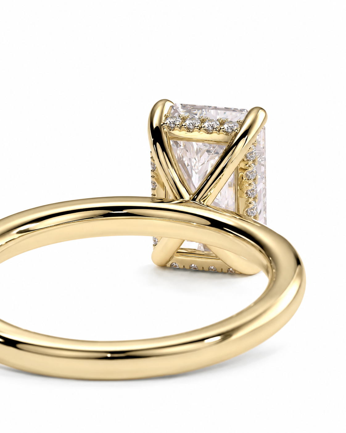 color_10K_YG, color_14K_YG &&A close-up shot of a yellow gold ring featuring a rectangular princess-cut clear gemstone surrounded by small accent diamonds, set in an X-shaped prong design with a polished band.
