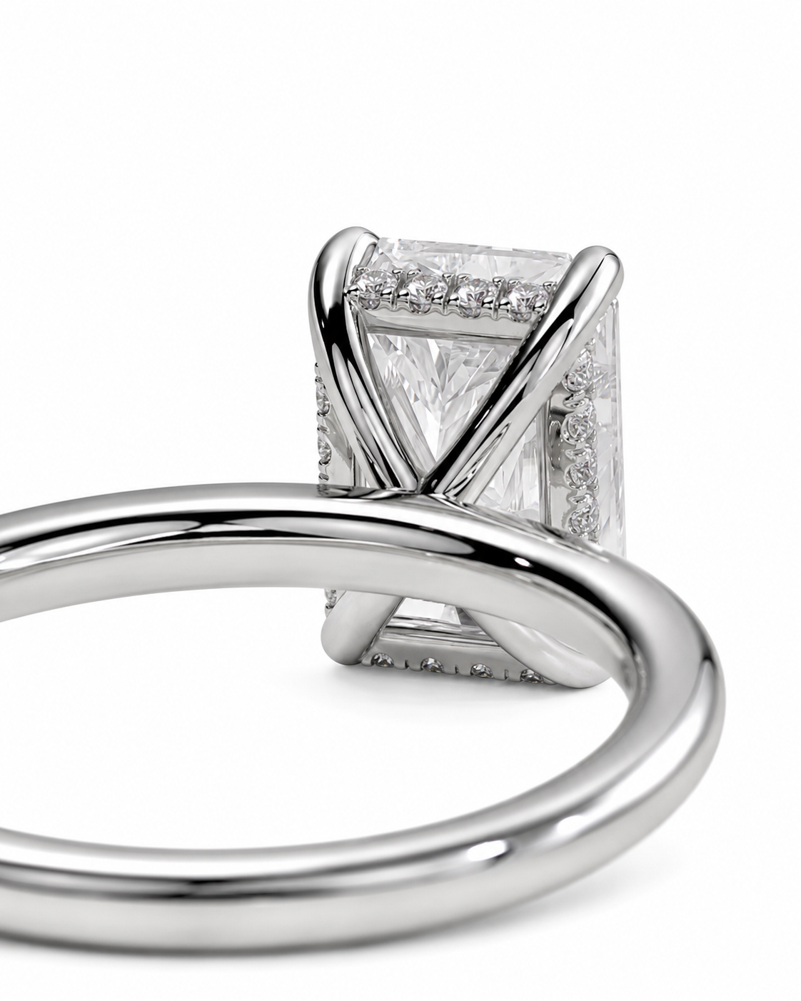 color_925_SIL,color_935_ARG,color_10K_WG, color_14K_WG &&Close-up of a silver-toned ring with a rectangular clear gemstone in a crossed-prong setting, surrounded by small accent stones, on a white background.