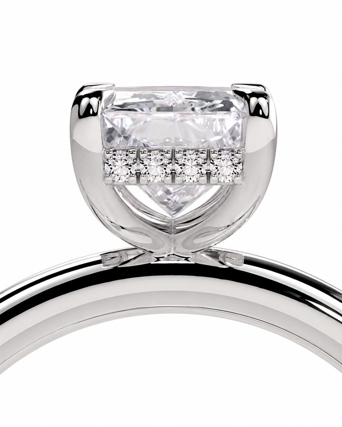 color_925_SIL,color_935_ARG,color_10K_WG, color_14K_WG &&A close-up studio shot of a silver-toned ring featuring a large rectangular clear center stone and a row of smaller clear stones across the top, set against a plain white background.
