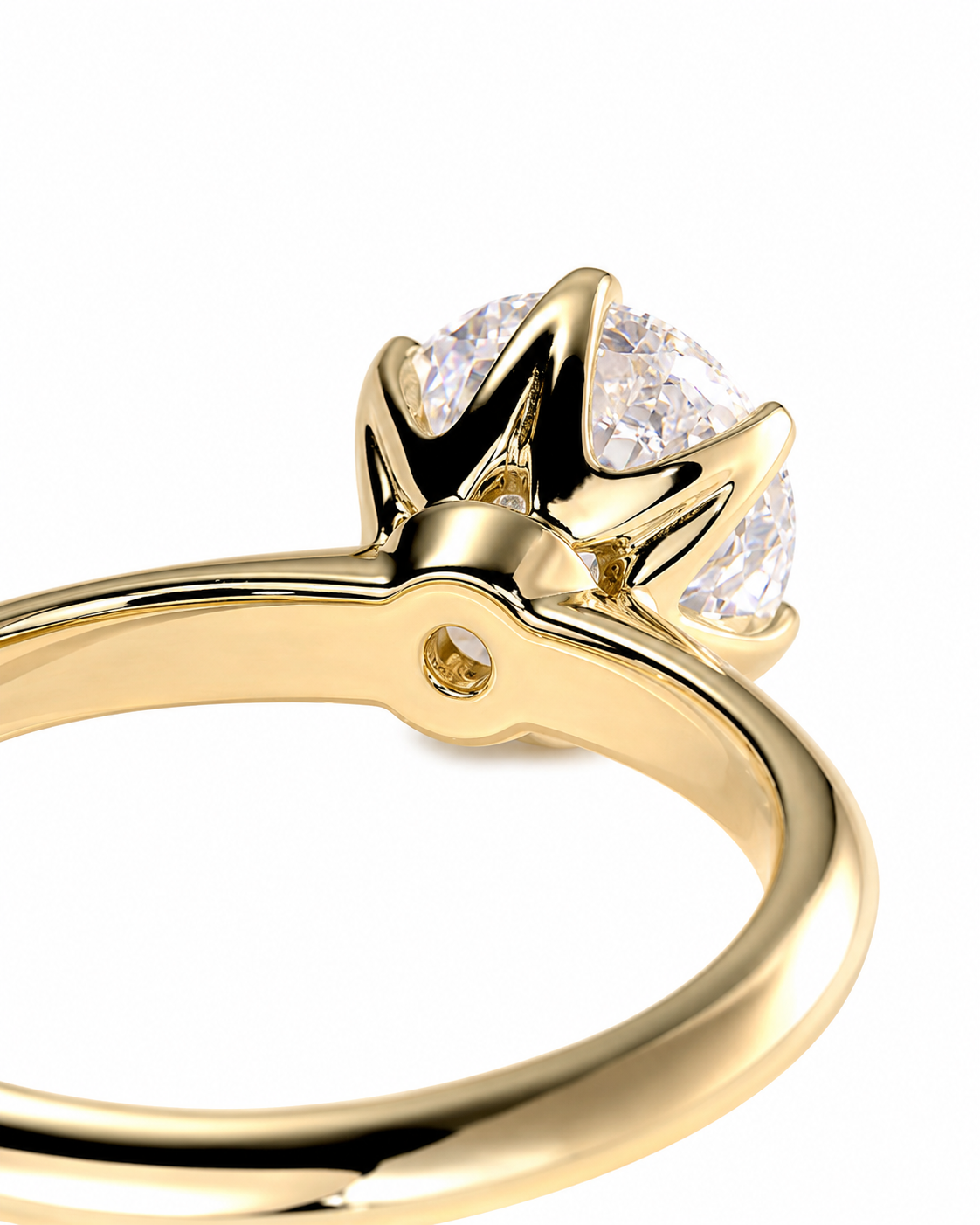 color_10K_YG, color_14K_YG &&A close-up shot of a yellow gold ring with a brilliant round-cut clear gemstone in a crown-like setting, shown on a plain white background.