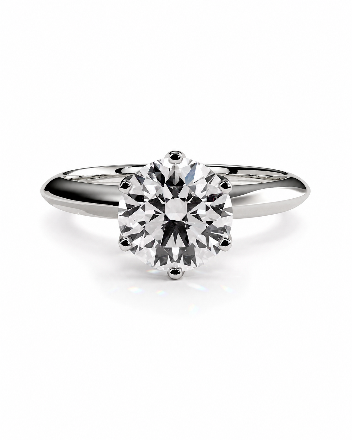 color_925_SIL,color_935_ARG,color_10K_WG, color_14K_WG &&A classic solitaire engagement ring featuring a round brilliant-cut diamond set in a polished silver-colored metal band, shown on a clean white background.