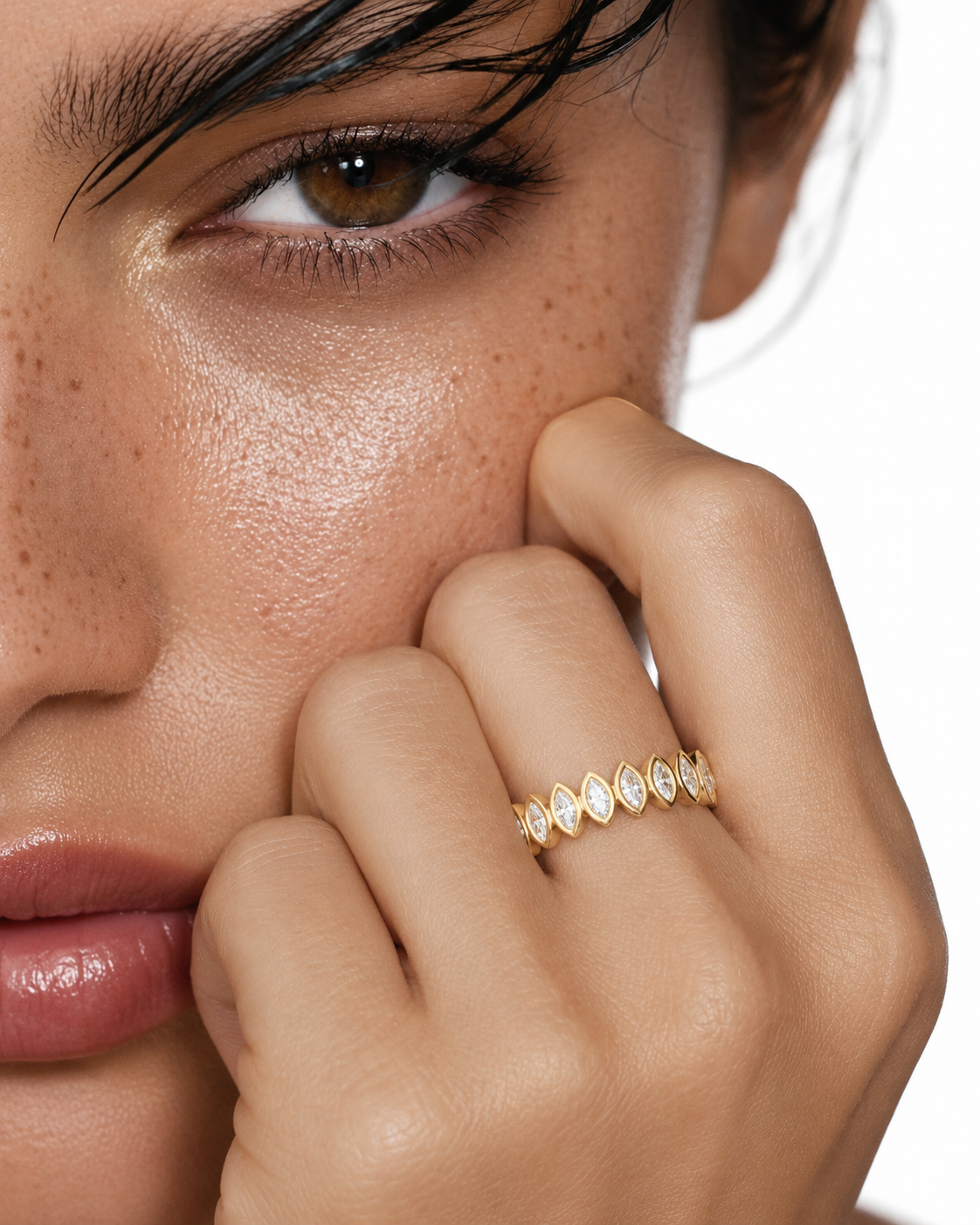 color_10K_YG, color_14K_YG &&	
Women's wedding band showcasing bezel-set marquise moissanite from an angled view.