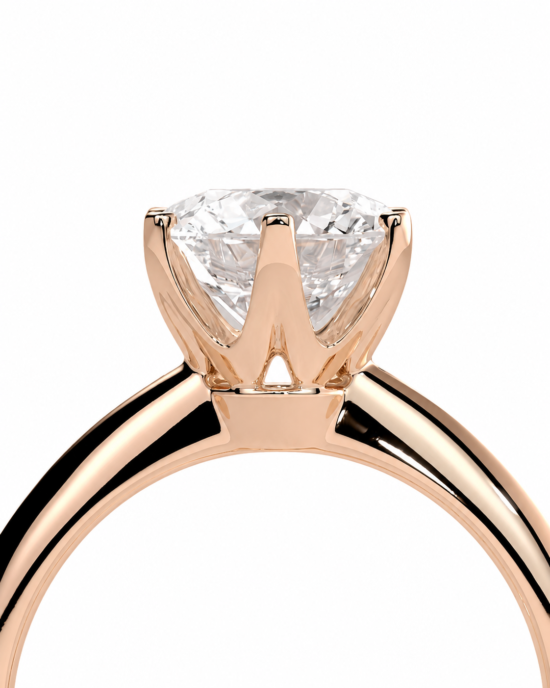 color_10K_RG, color_14K_RG &&A close-up of a rose gold solitaire engagement ring with a round brilliant-cut diamond set in a four-prong crown, shown against a solid white background.
