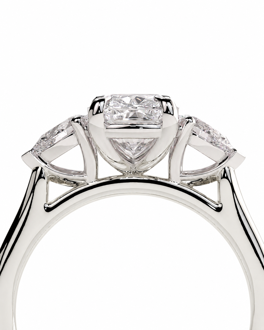 color_925_SIL,color_935_ARG,color_10K_WG, color_14K_WG &&A close-up studio shot of a silver-toned diamond ring featuring a central princess-cut diamond and two marquise-cut diamonds on either side, set against a plain white background.