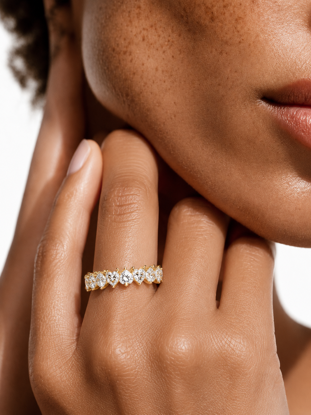 color_10K_YG, color_14K_YG &&	
Angled view of a heart-cut moissanite wedding band for women with an eternity silhouette.
