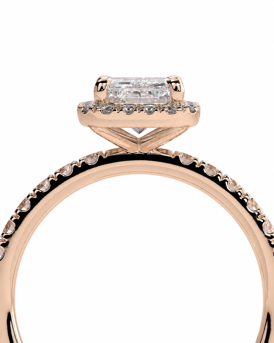 color_10K_RG, color_14K_RG &&Rose gold engagement ring with a rectangular baguette-cut clear center stone and a halo accent setting, shown on a plain white background.