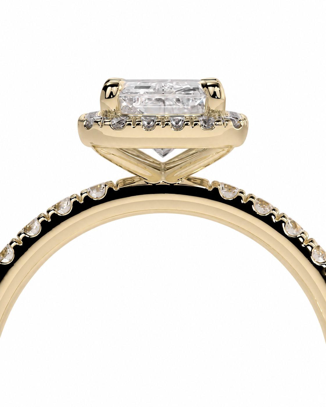color_10K_YG, color_14K_YG &&A close-up of a yellow gold ring featuring a rectangular clear gemstone in a prong setting, with a halo of small clear stones and a matching diamond band.