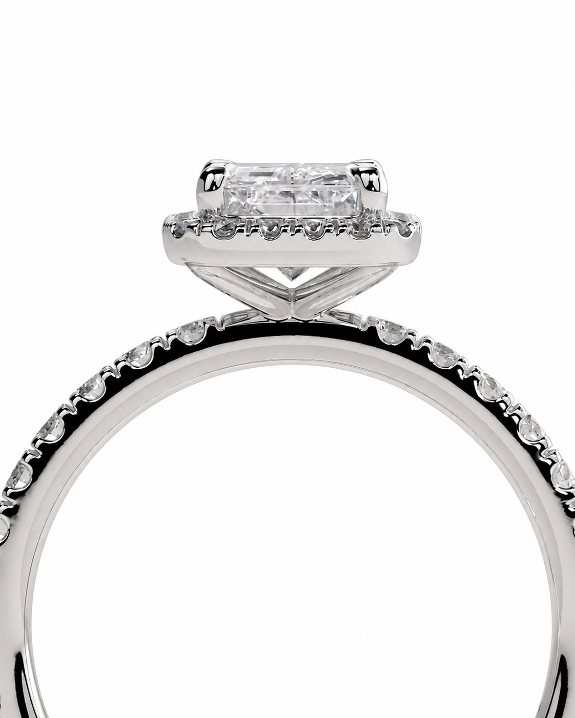 color_925_SIL,color_935_ARG,color_10K_WG, color_14K_WG &&A close-up studio shot of a silver-toned diamond ring featuring a rectangular emerald-cut center stone in a halo setting, with a pave band.