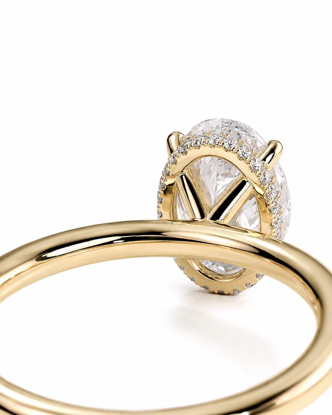 color_10K_YG, color_14K_YG &&Close-up of a gold ring with a large oval clear gemstone surrounded by small pave-set stones, photographed on a clean white background.