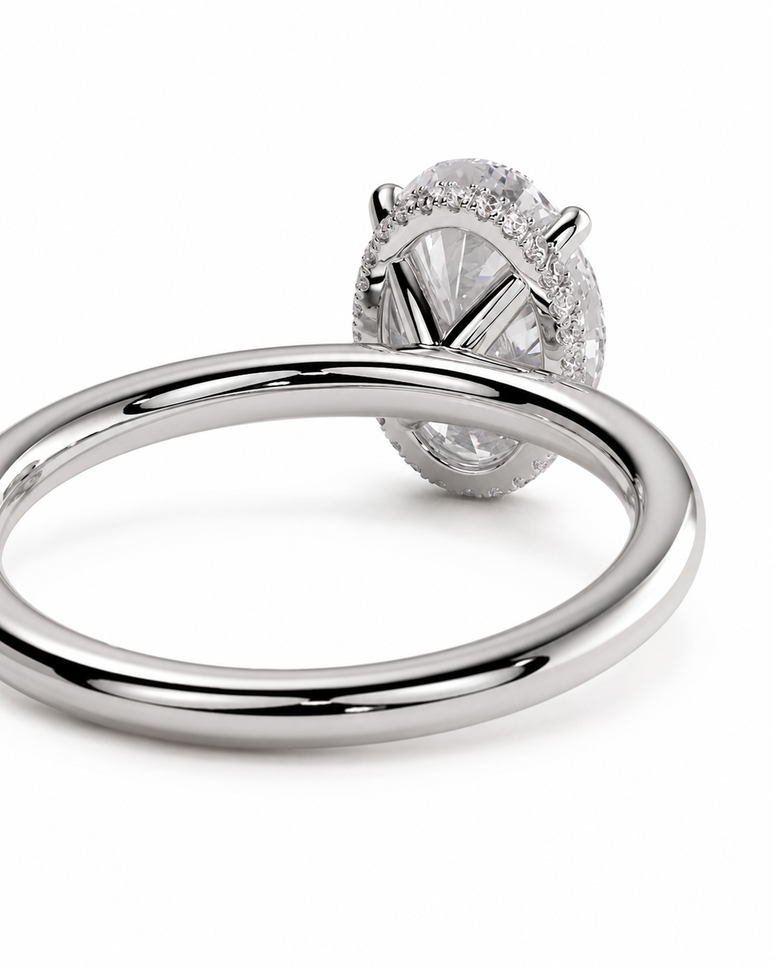 color_925_SIL,color_935_ARG,color_10K_WG, color_14K_WG &&A close-up studio shot of a silver-toned ring with a large oval clear gemstone and a halo of smaller stones, shown on a clean white background.