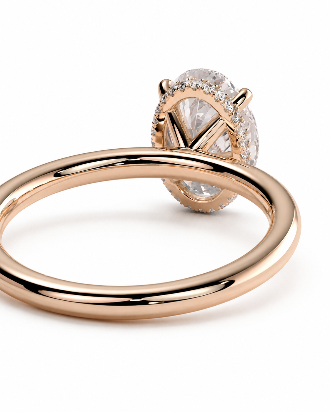 color_10K_RG, color_14K_RG &&A rose gold ring with a large oval clear gemstone and a halo of smaller diamonds, shown on a clean white background.