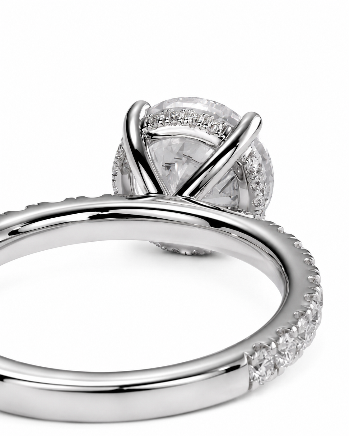 color_925_SIL,color_935_ARG,color_10K_WG, color_14K_WG &&A close-up studio shot of a silver-toned ring with a large clear round center stone and a halo of smaller clear stones, set against a plain white background.