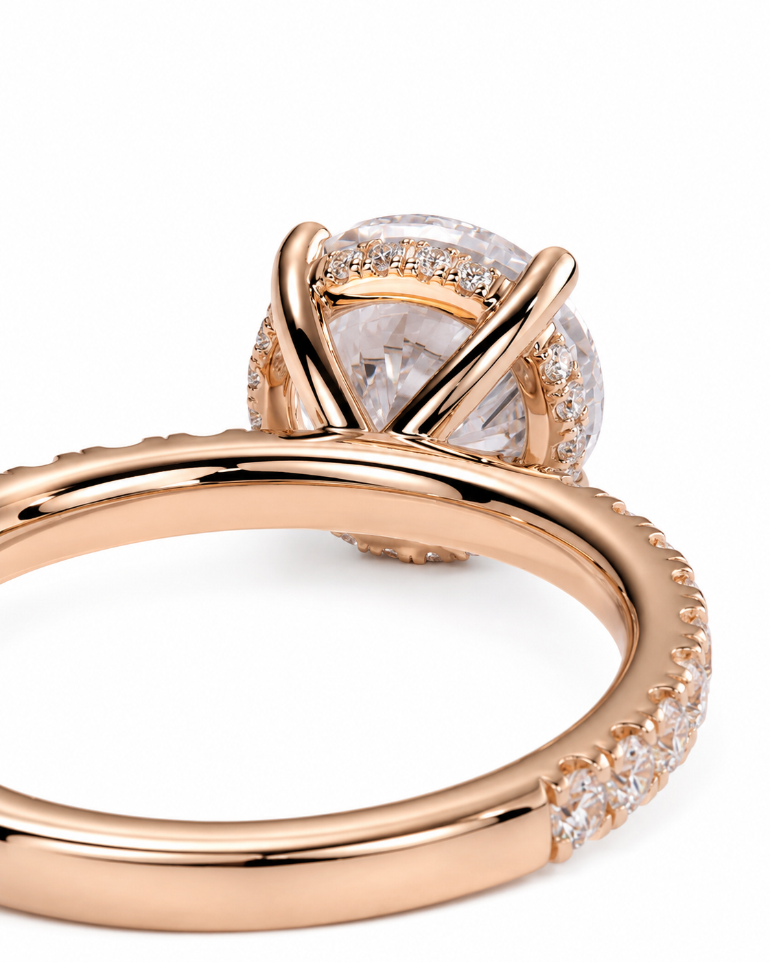 color_10K_RG, color_14K_RG &&Rose gold ring with a large oval clear gemstone in a halo setting, accented by pave stones on the band, shown on a white background.