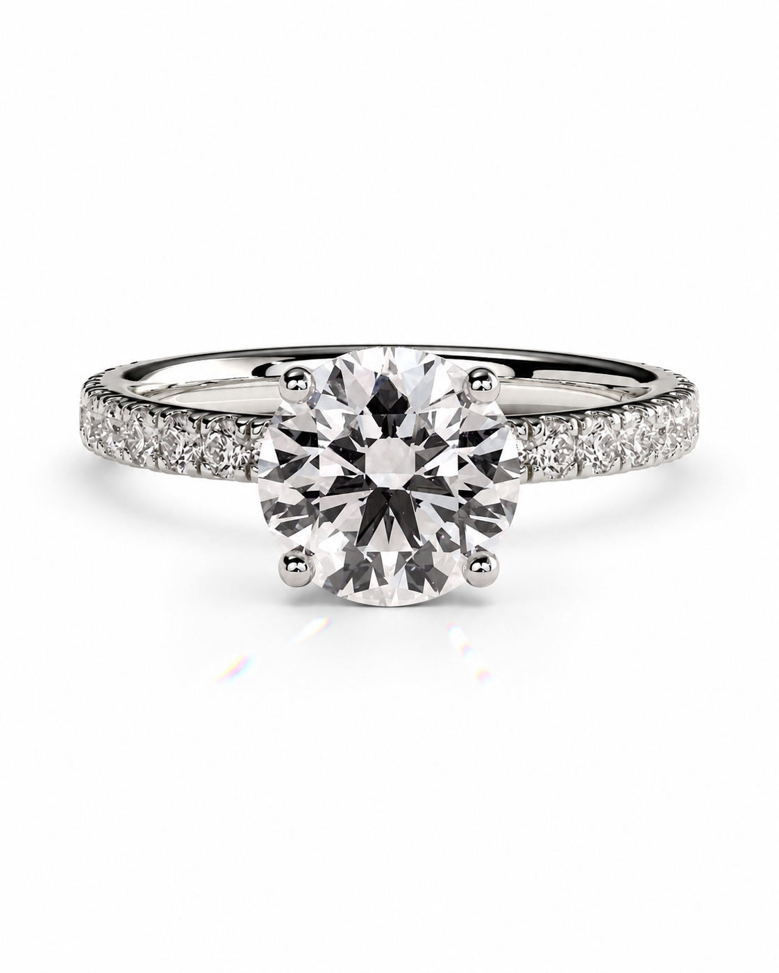 color_925_SIL,color_935_ARG,color_10K_WG, color_14K_WG &&A round-cut solitaire diamond engagement ring with a pave-set diamond band in a silver-colored metal, shown on a clean white background.