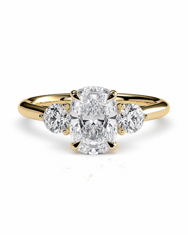 color_10K_YG, color_14K_YG &&A yellow gold three-stone engagement ring featuring a large oval center diamond flanked by two round side diamonds, set against a clean white background.