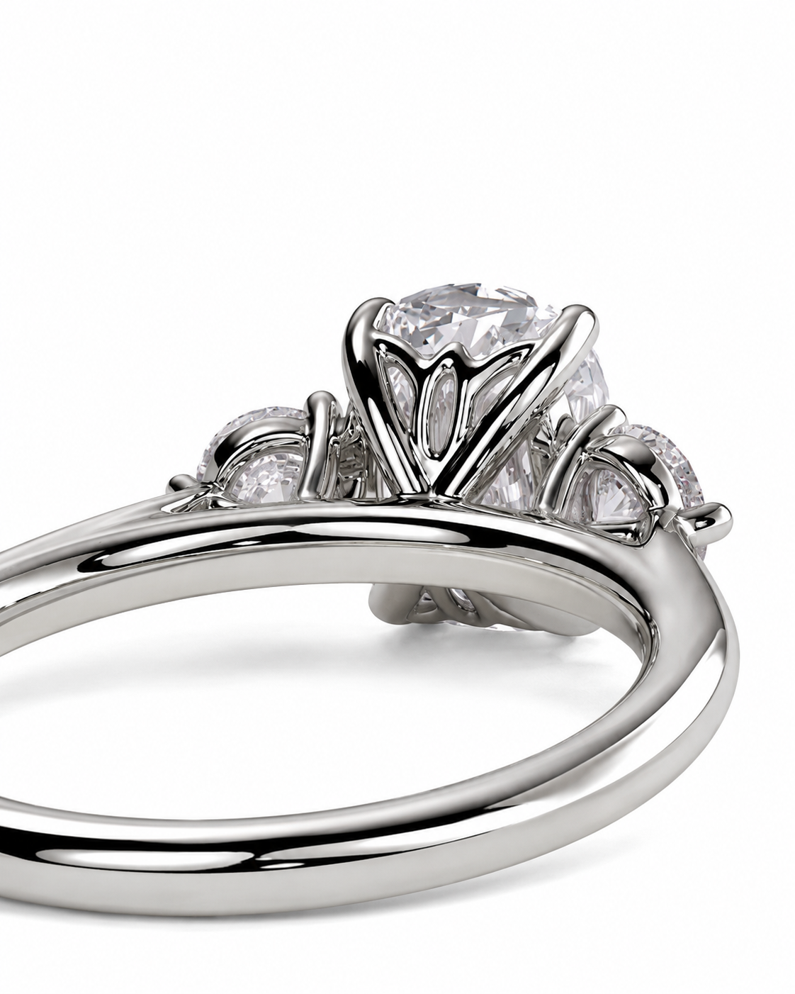 color_925_SIL,color_935_ARG,color_10K_WG, color_14K_WG &&A close-up studio shot of a silver-toned ring with a large clear round center stone and smaller accent stones on a white background.