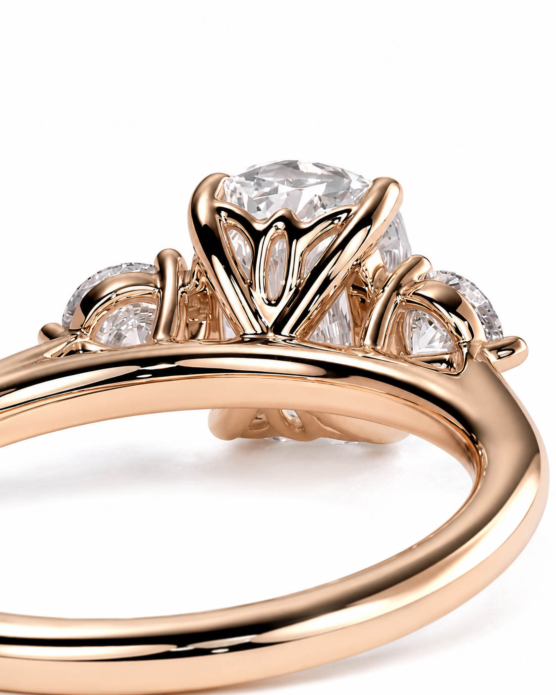 color_10K_RG, color_14K_RG &&Rose gold ring with a large round clear center stone and smaller side stones, shown in a close-up studio shot on a white background.