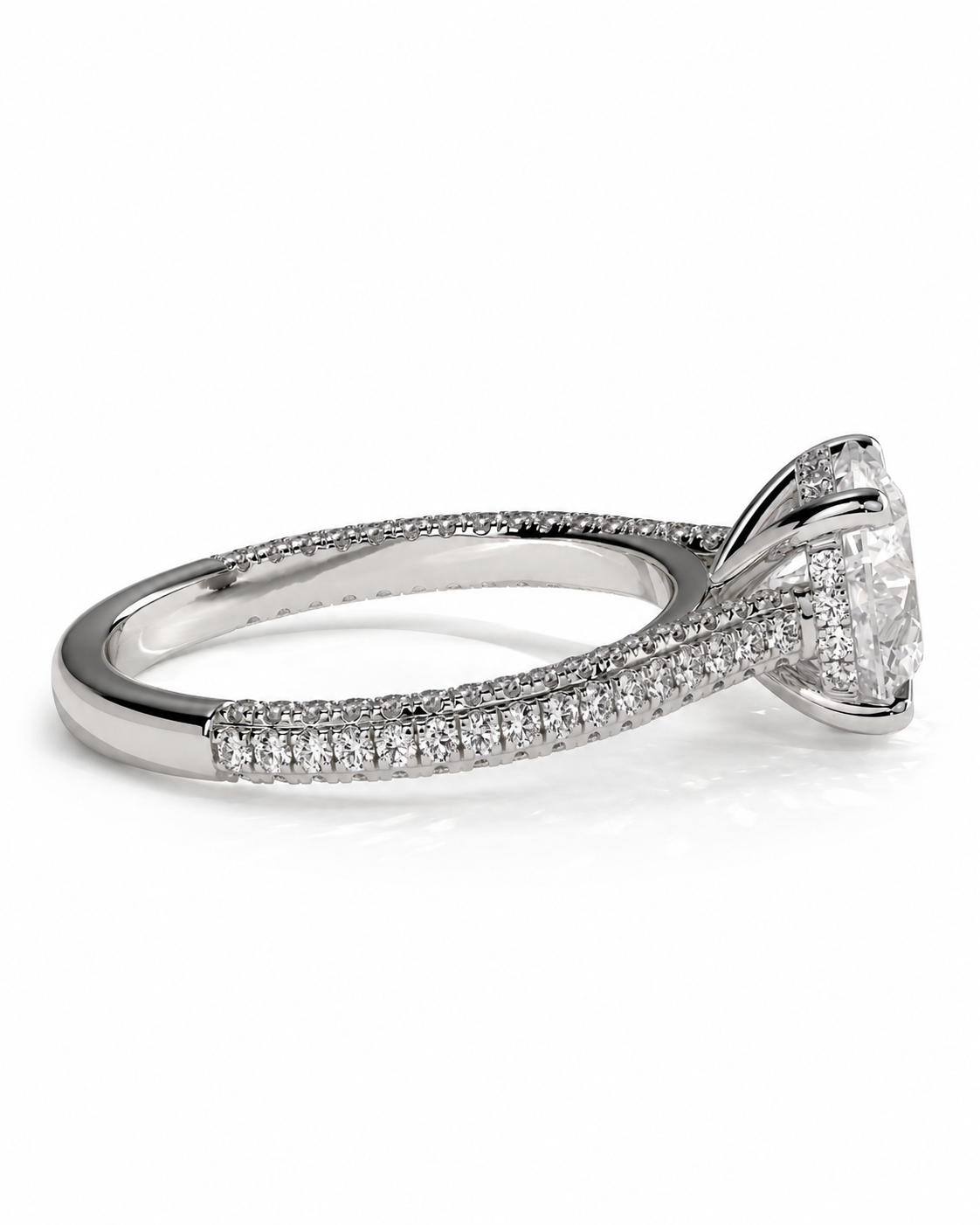 color_925_SIL,color_935_ARG,color_10K_WG, color_14K_WG &&A silver-toned diamond engagement ring with a round-cut center stone and pave-set diamonds along the shank, shown on a clean white background.