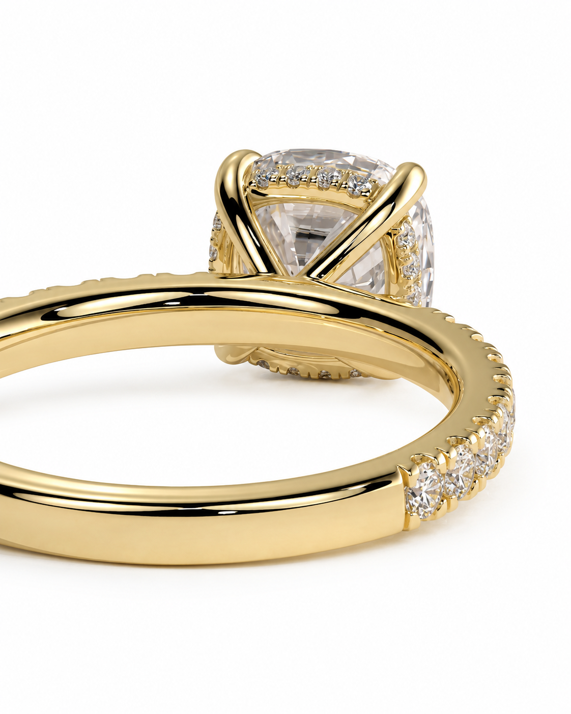 color_10K_YG, color_14K_YG &&A close-up of a yellow gold ring featuring a large cushion-cut clear center stone and small pave diamonds along the band, set against a plain white background.