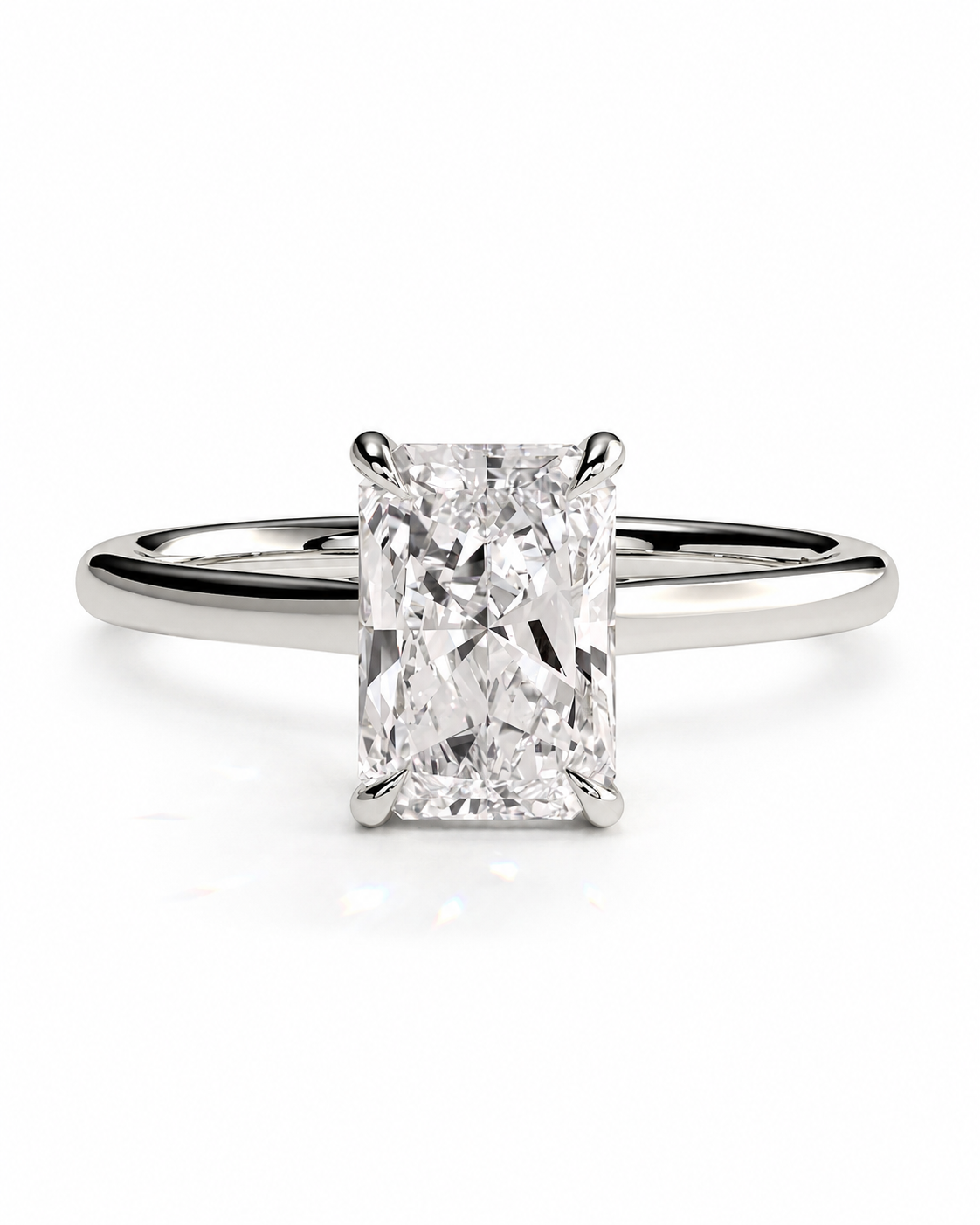 color_925_SIL,color_935_ARG,color_10K_WG, color_14K_WG &&An radiant cut diamond engagement ring with a polished silver-colored band, centered on a clean white background.