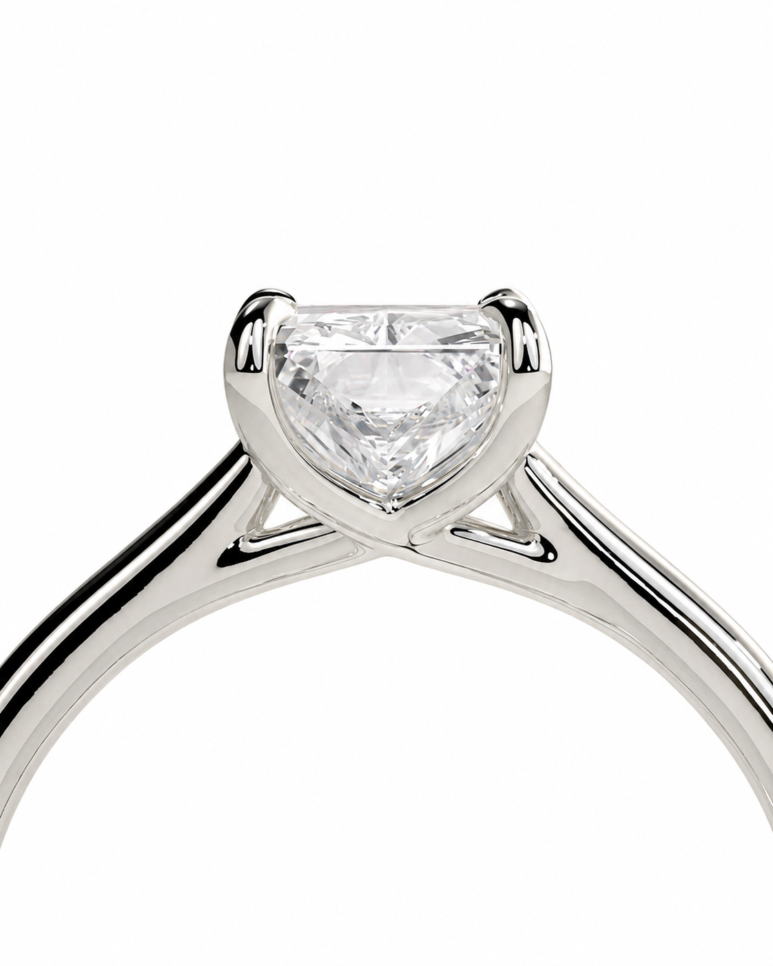 color_925_SIL,color_935_ARG,color_10K_WG, color_14K_WG &&A close-up studio shot of a silver-toned solitaire engagement ring with a heart-shaped clear gemstone, set against a solid white background.