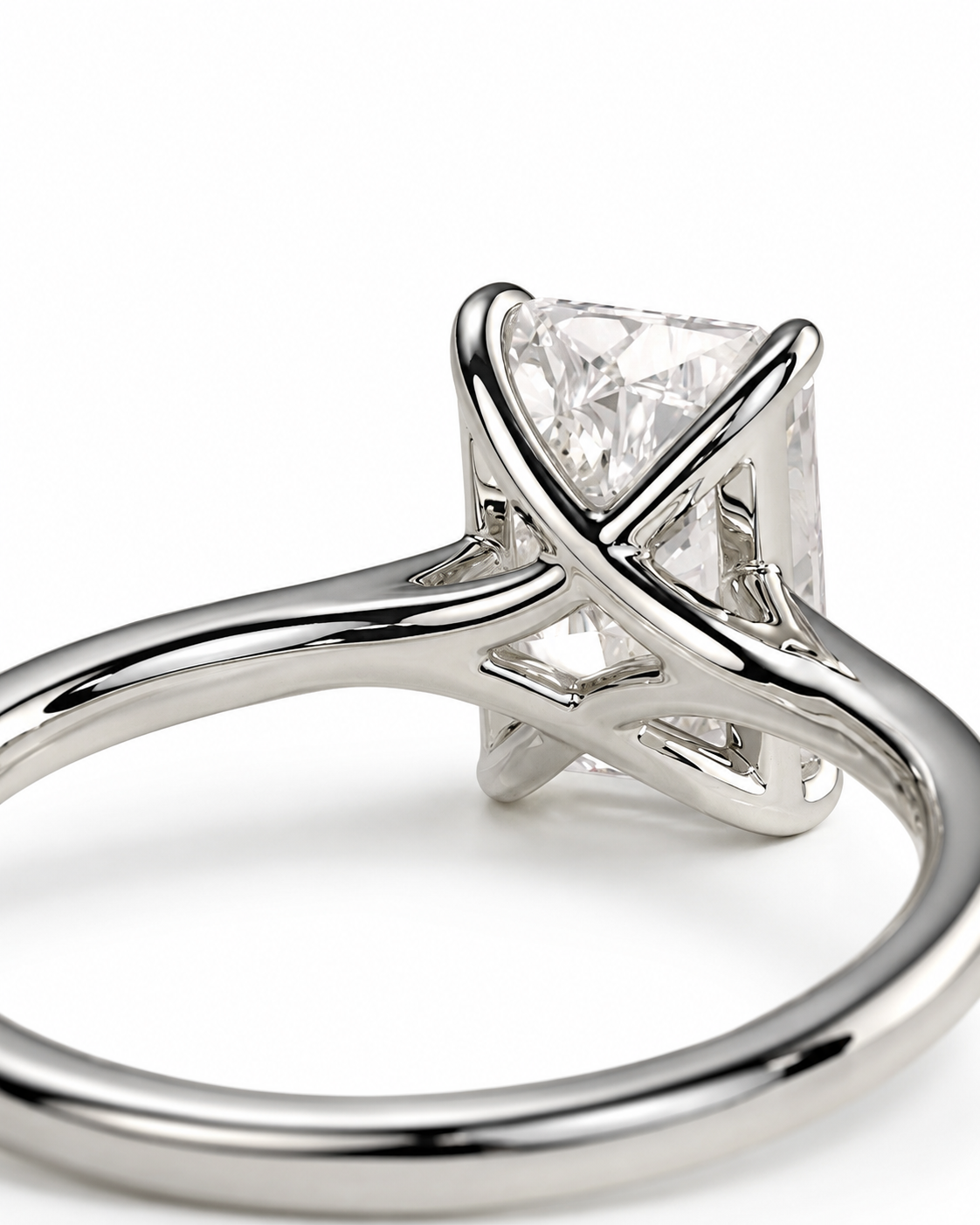 color_925_SIL,color_935_ARG,color_10K_WG, color_14K_WG &&A close-up shot of a silver-toned solitaire engagement ring with a rectangular clear gemstone, set against a clean white background.