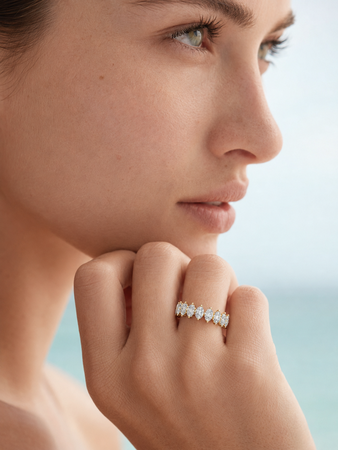 color_10K_YG, color_14K_YG &&Premium full eternity wedding band showcasing marquise moissanite from angled perspective.