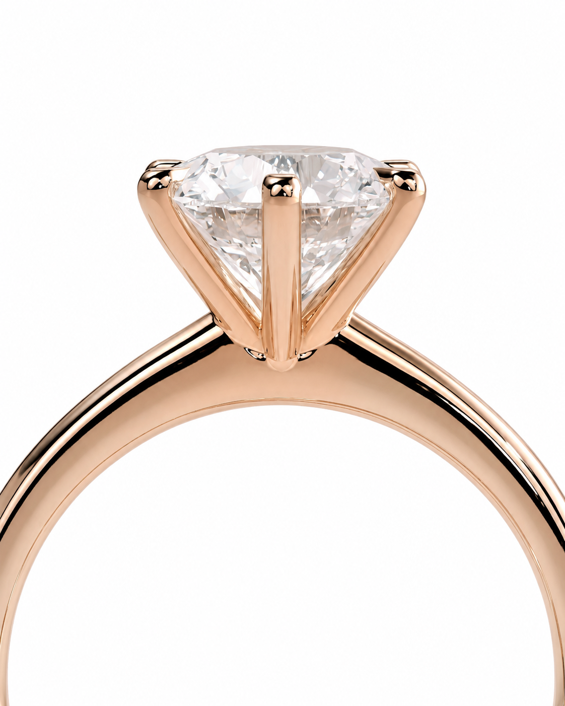 color_10K_RG, color_14K_RG &&A close-up of a rose gold solitaire engagement ring featuring a triangular-cut clear gemstone in a four-prong setting, shown against a solid white background.