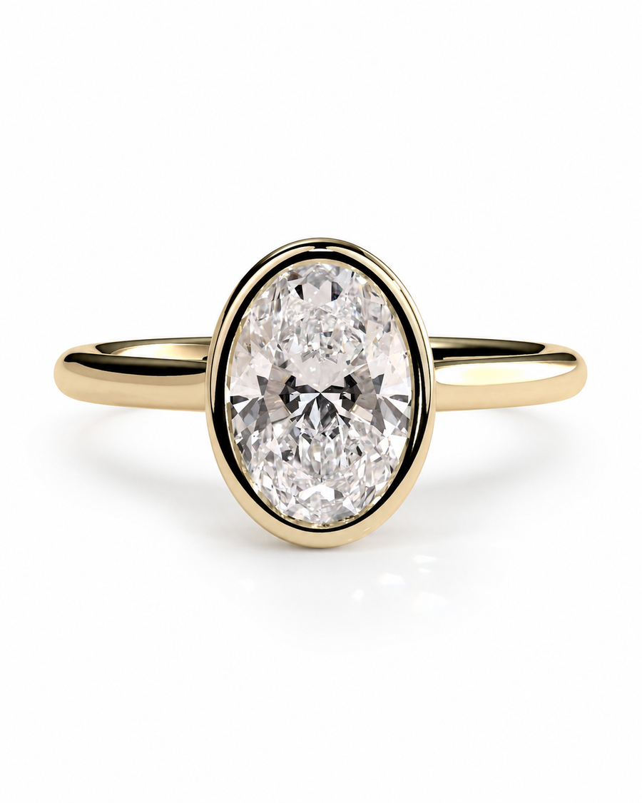 color_10K_YG, color_14K_YG &&A yellow gold ring featuring a large oval-cut clear gemstone in a bezel setting, shown on a clean white background.