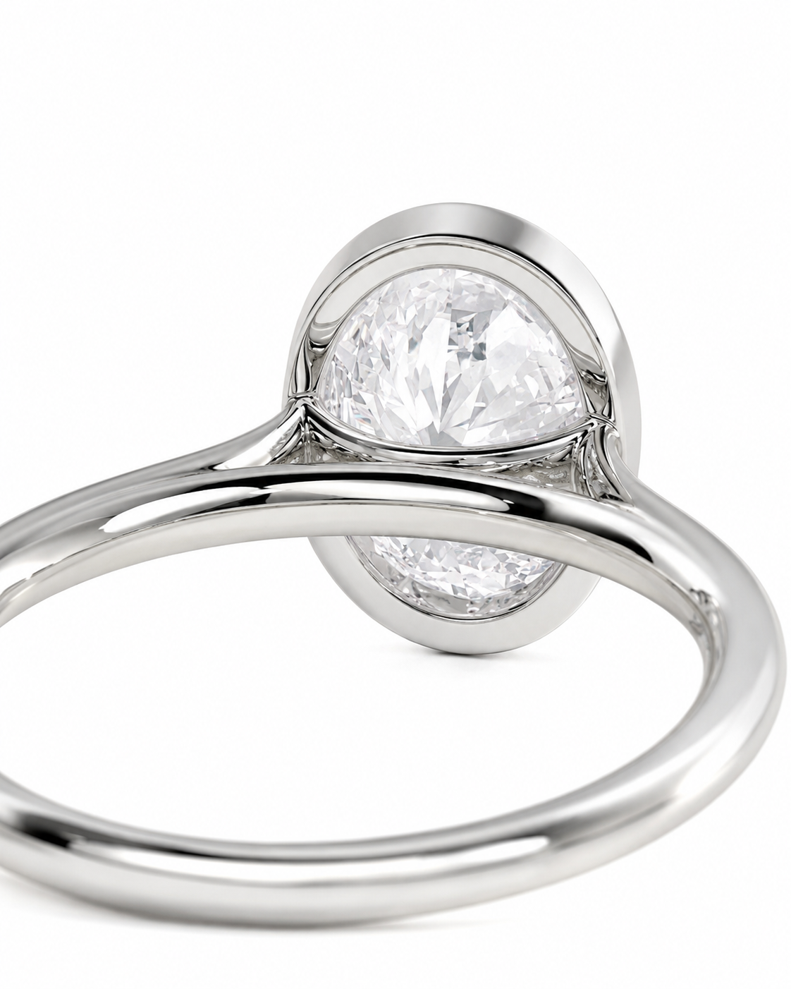 color_925_SIL,color_935_ARG,color_10K_WG, color_14K_WG &&A close-up shot of a silver-toned ring featuring a large, round brilliant-cut clear gemstone in a bezel setting, with a smaller matching round stone set in the back, on a plain white background.