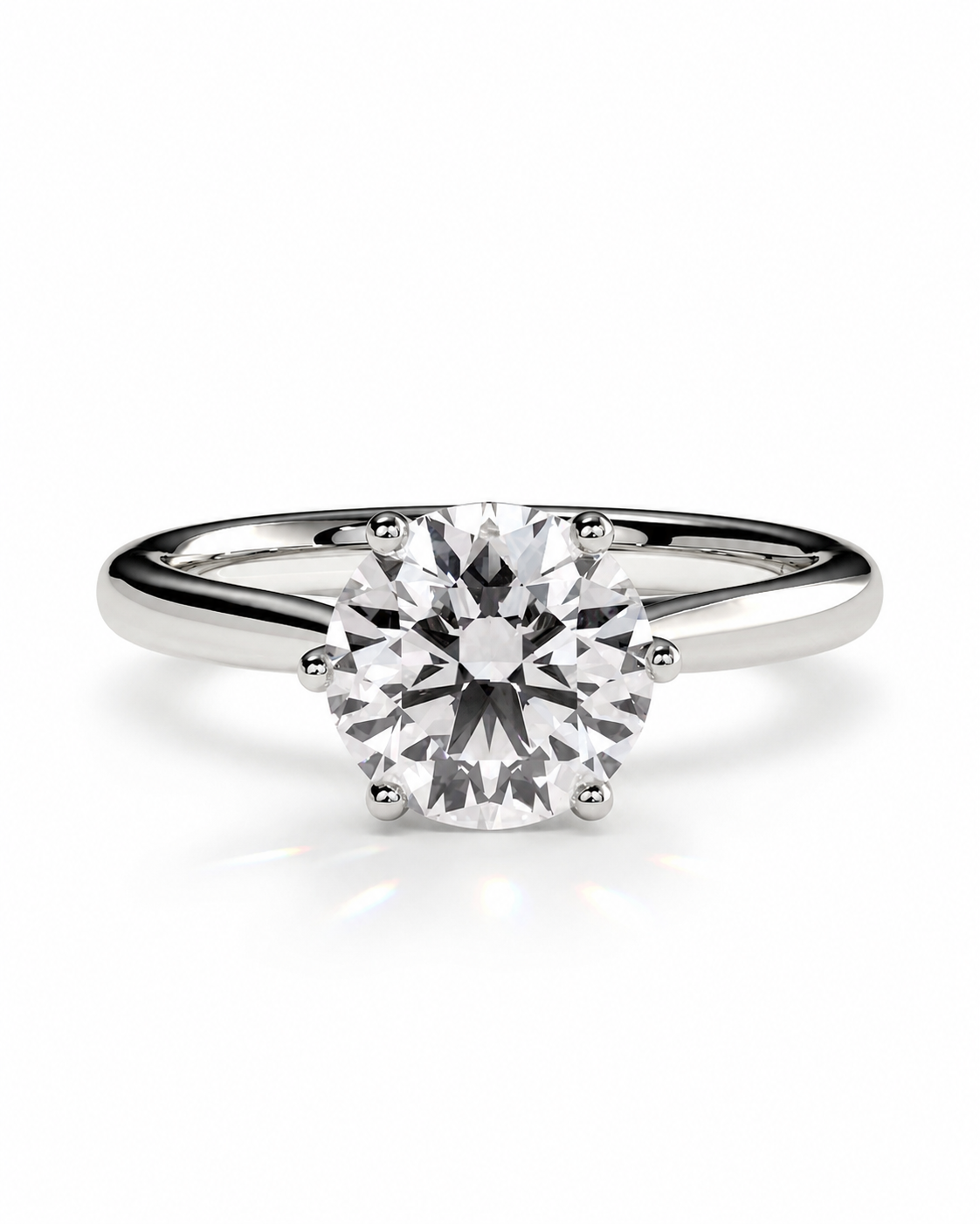 color_925_SIL,color_935_ARG,color_10K_WG, color_14K_WG &&A classic solitaire engagement ring featuring a round brilliant-cut diamond set in a polished white gold or platinum band, shown on a clean white background with a soft reflection.