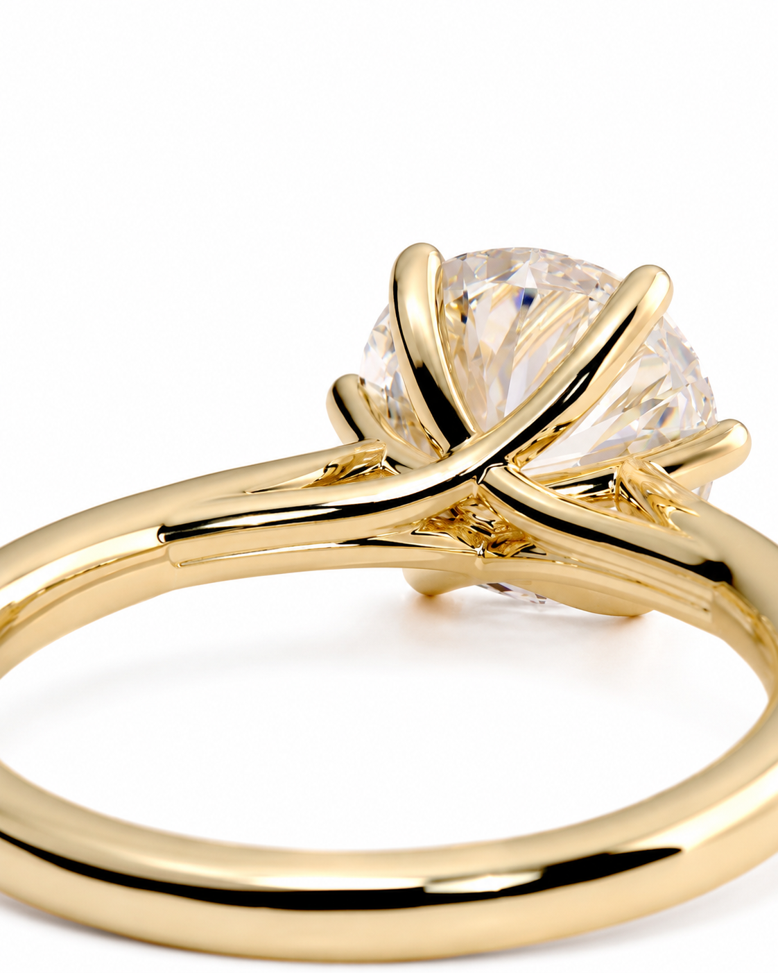 color_10K_YG, color_14K_YG &&A close-up shot of a yellow gold solitaire engagement ring with a round brilliant-cut clear gemstone in a prong setting, on a clean white background.