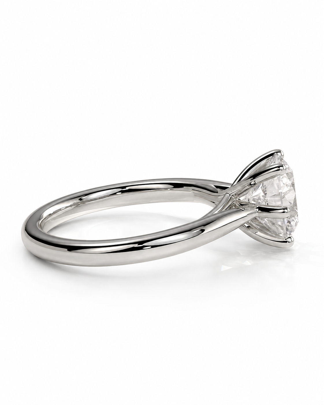 color_925_SIL,color_935_ARG,color_10K_WG, color_14K_WG &&A silver-toned solitaire engagement ring with a clear round-cut gemstone in a four-prong setting, shown on a clean white background.