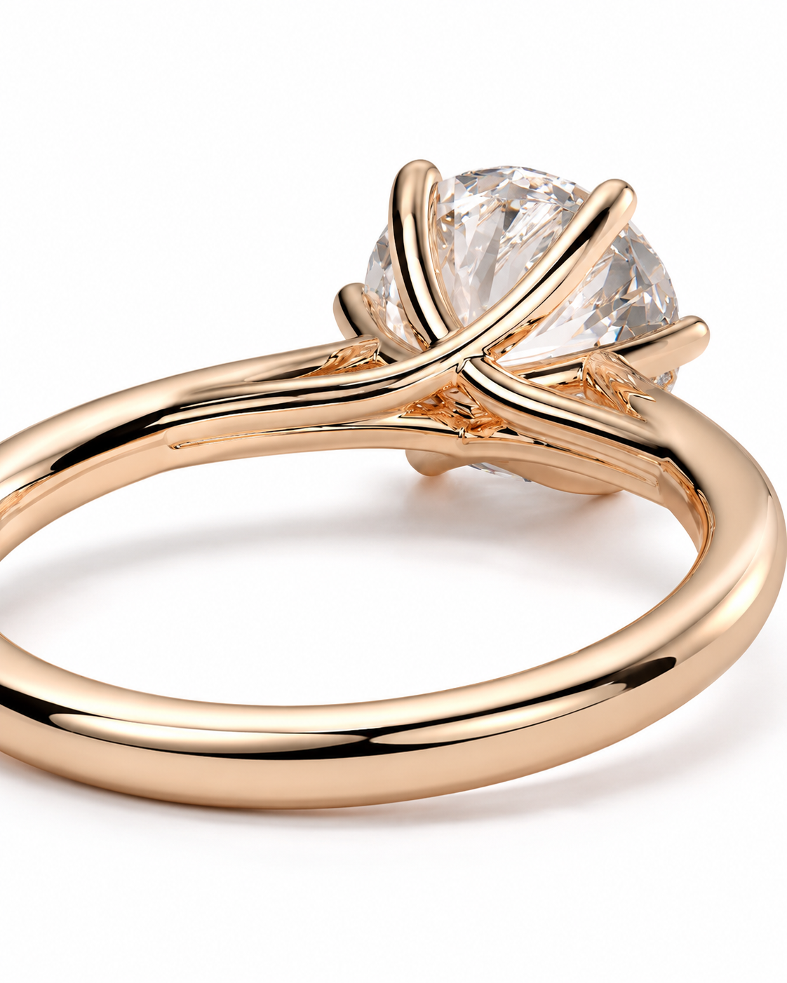 color_10K_RG, color_14K_RG &&A close-up shot of a rose gold ring with a clear round-cut gemstone in a unique crisscross prong setting, shown on a white background.