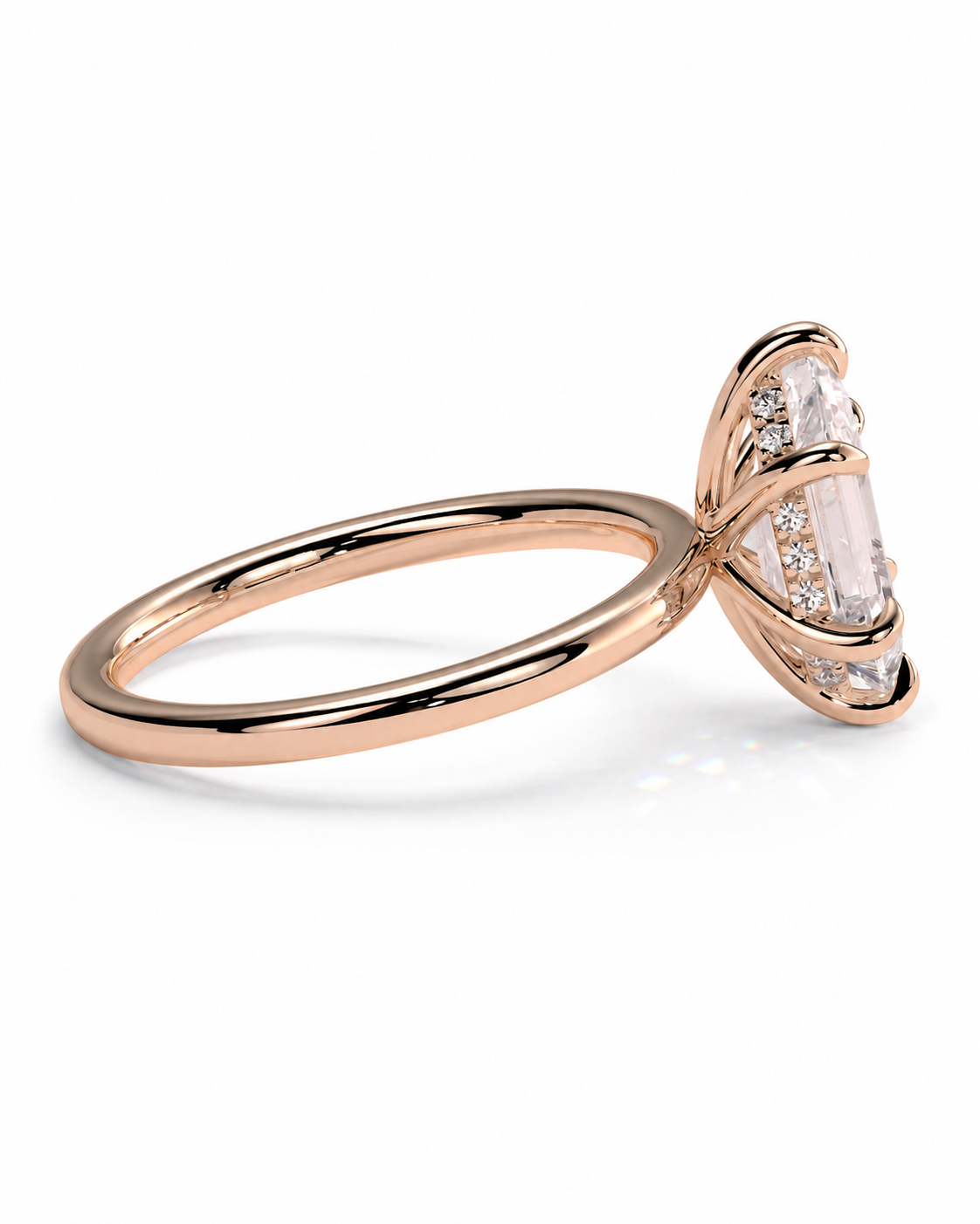 color_10K_RG, color_14K_RG &&A rose gold ring featuring a marquise-cut clear gemstone in a prong setting with smaller accent stones along the side, shown on a clean white background.