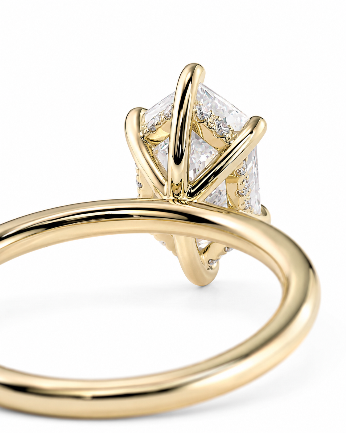 color_10K_YG, color_14K_YG &&A close-up shot of a yellow gold ring featuring a large, clear rectangular gemstone in a unique prong setting, with a polished gold band on a white background.