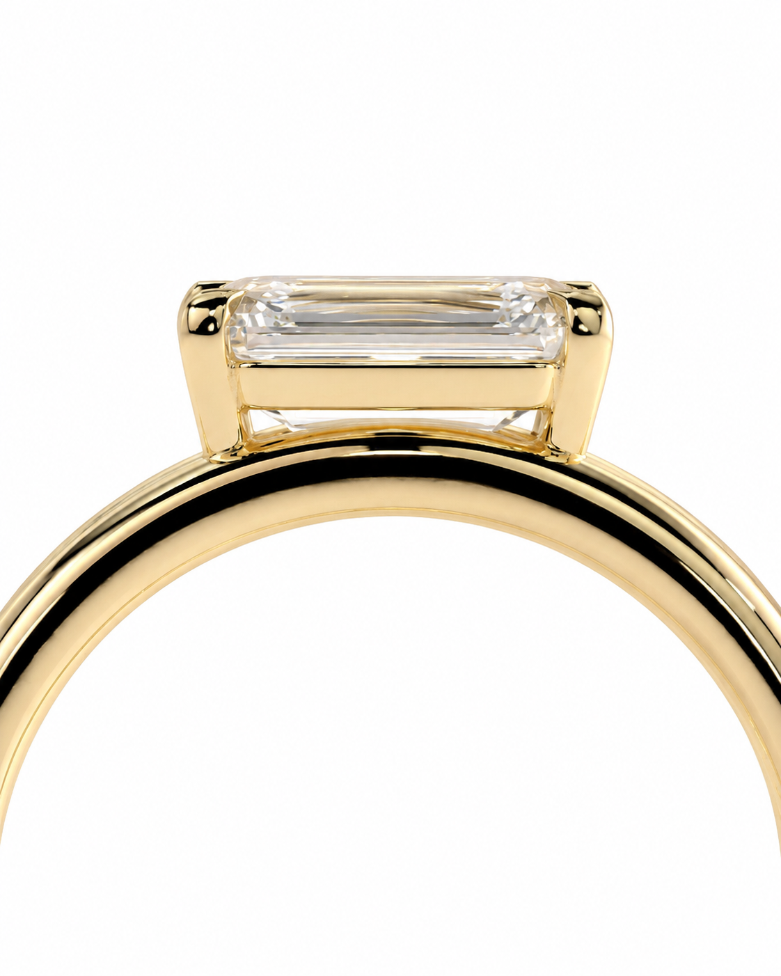 color_10K_YG, color_14K_YG &&A close-up of a yellow gold ring featuring a rectangular baguette-cut clear gemstone in a prong setting, shown against a plain white background.