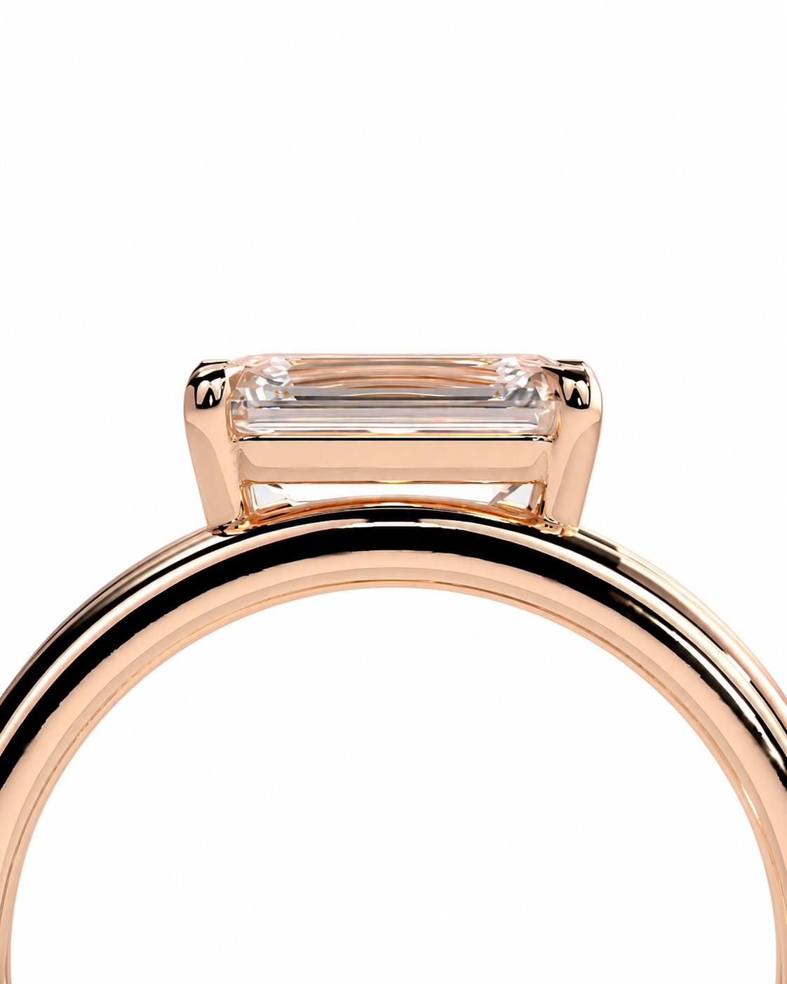 color_10K_RG, color_14K_RG &&Close-up of a rose gold ring with a rectangular clear baguette-cut gemstone in a prong setting, shown against a plain white background.