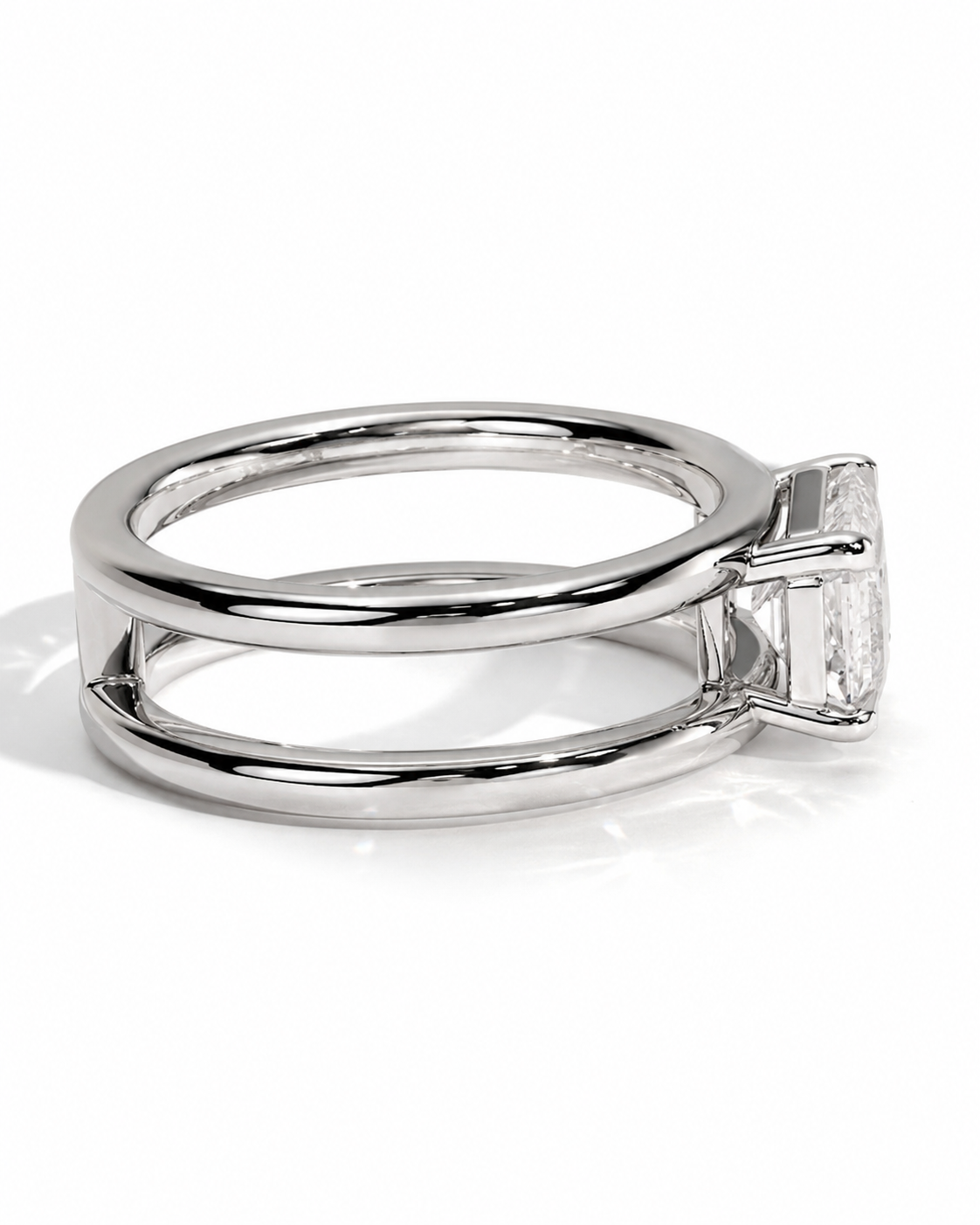 color_925_SIL,color_935_ARG,color_10K_WG, color_14K_WG &&A polished silver-tone ring featuring a double-band design and a large rectangular clear gemstone in a prong setting, shown on a clean white background.