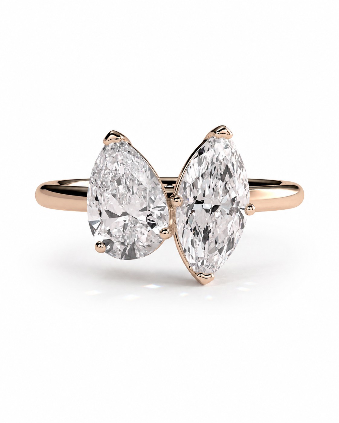 color_10K_RG, color_14K_RG &&A rose gold ring featuring two pear-cut diamonds set side-by-side on a clean white background.