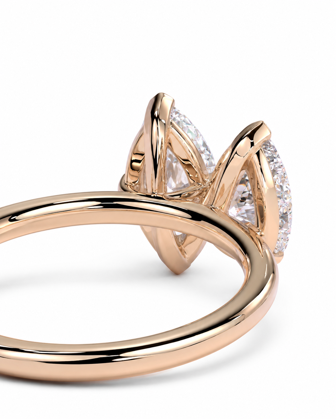 color_10K_RG, color_14K_RG &&A close-up of a rose gold ring featuring a unique multi-stone setting with marquise-cut and round brilliant-cut clear gemstones, shown on a clean white background.