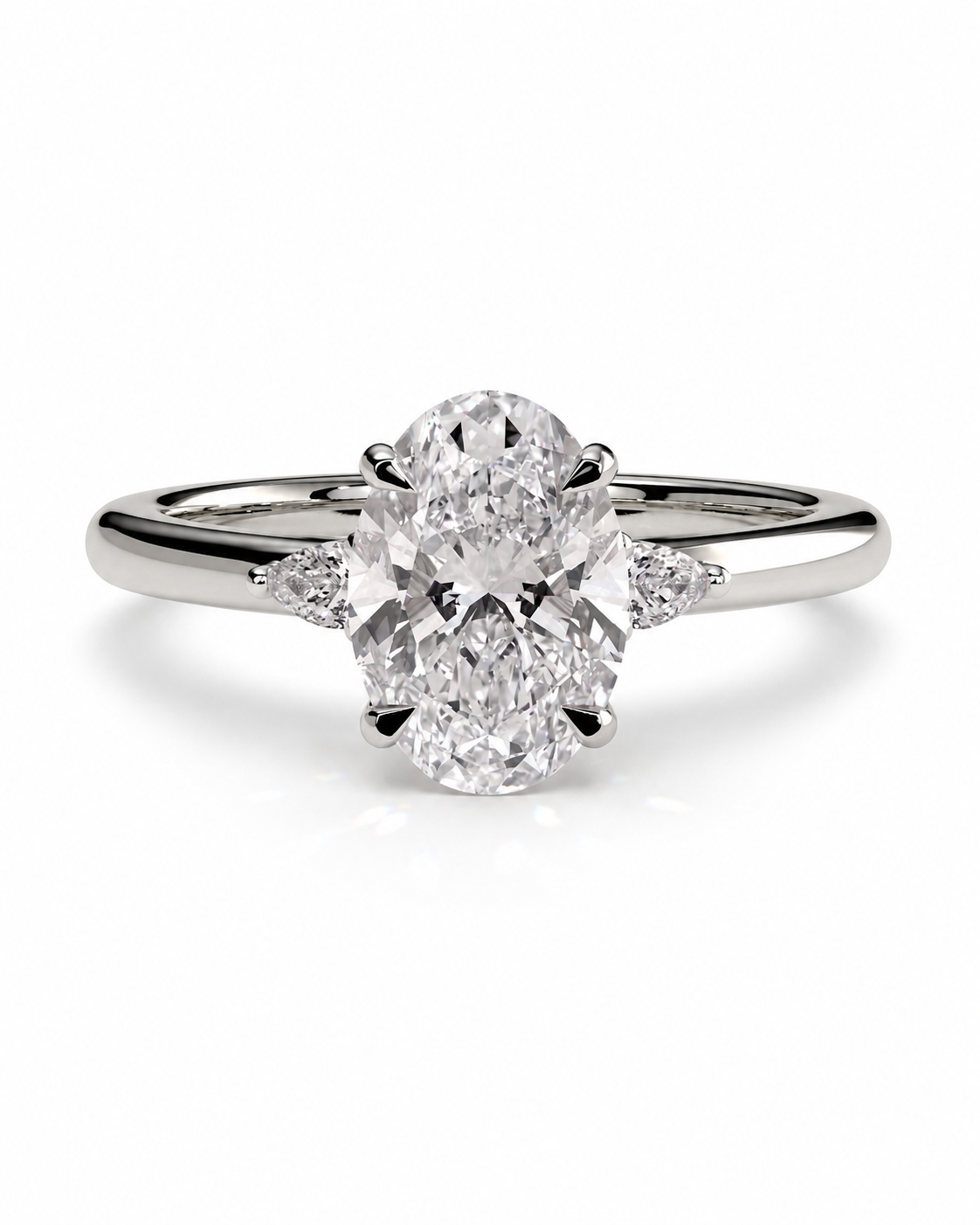 color_925_SIL,color_935_ARG,color_10K_WG, color_14K_WG &&An oval diamond engagement ring with a brilliant-cut center stone and small side diamonds on a polished silver-colored band, set against a clean white background.