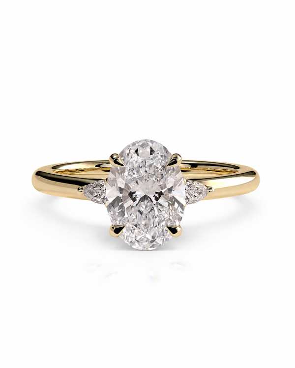 color_10K_YG, color_14K_YG &&A yellow gold diamond ring with a large oval-cut center stone and small side stones, shown on a clean white background.