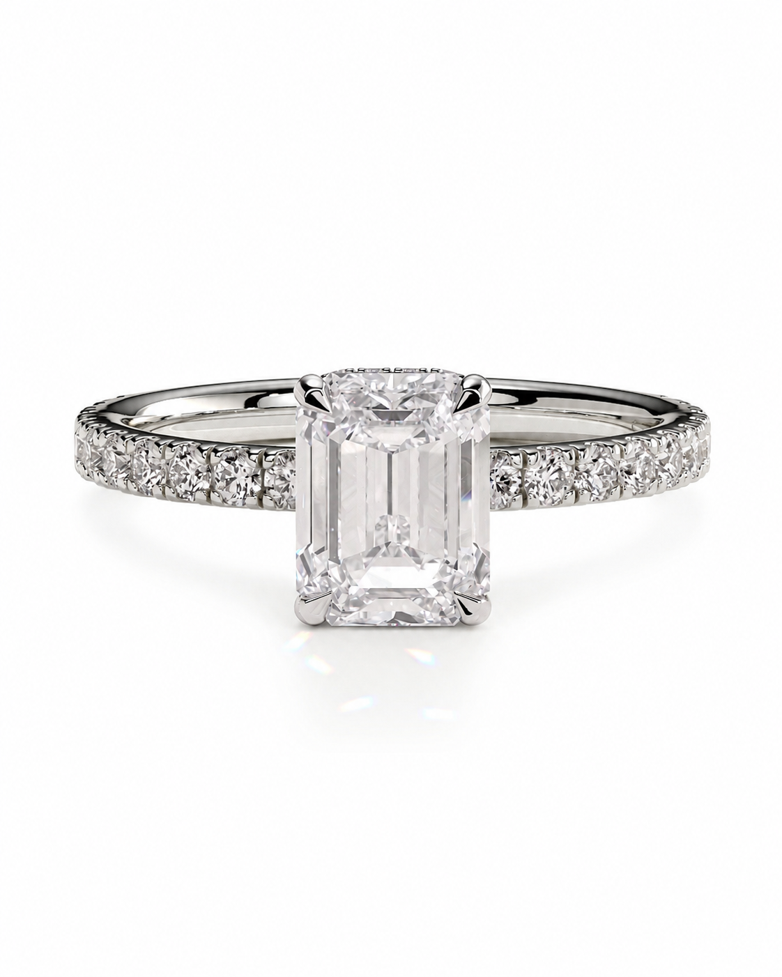 color_925_SIL,color_935_ARG,color_10K_WG, color_14K_WG &&An emerald-cut diamond engagement ring with a pave band, set in a silver-colored metal on a clean white background.